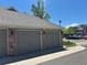 Two-car detached garages with brick accents and gray doors in a well-maintained community at 16366 E Fremont Ave # 11, Aurora, CO 80016