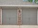 Attached garages with gray doors and brick accents at 16366 E Fremont Ave # 11, Aurora, CO 80016