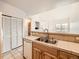 Kitchen featuring tile countertops, a double sink, and white appliances at 16366 E Fremont Ave # 11, Aurora, CO 80016