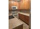Traditional kitchen featuring wood cabinets, white appliances, and tile countertops at 16366 E Fremont Ave # 11, Aurora, CO 80016
