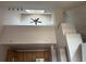 Bright living room featuring high ceilings, skylight, modern fan, and architectural columns at 16366 E Fremont Ave # 11, Aurora, CO 80016