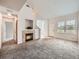 Bright living room featuring a cozy fireplace, carpeted flooring, and natural light at 16366 E Fremont Ave # 11, Aurora, CO 80016