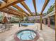 Outdoor community area with a pool, hot tub, lounge chairs, and a shaded pergola at 16366 E Fremont Ave # 11, Aurora, CO 80016