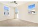 Bright, carpeted bedroom with three windows offering natural light and views of the neighborhood at 5745 W 91St Ave, Westminster, CO 80031