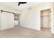 Bedroom featuring a sliding barn door, neutral carpet, and a walk-in closet with ample storage space at 5745 W 91St Ave, Westminster, CO 80031