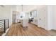 Modern kitchen with stainless steel appliances, a kitchen island, and light gray cabinets with wood flooring at 5745 W 91St Ave, Westminster, CO 80031