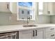 Modern kitchen featuring white countertops, a stainless steel sink, and white cabinets with black hardware at 5745 W 91St Ave, Westminster, CO 80031