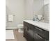 Bright bathroom with a dark vanity, marble countertop, large mirror, and modern fixtures at 6619 E Lowry Blvd # 101, Denver, CO 80230