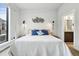Inviting bedroom showcasing serene decor, ample natural light, and a bathroom view at 6619 E Lowry Blvd # 101, Denver, CO 80230