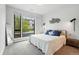 Bright bedroom featuring large window, plush bedding, and modern decor at 6619 E Lowry Blvd # 101, Denver, CO 80230