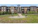 Well-maintained apartment building with balconies overlooking a landscaped common area, benches and art at 6619 E Lowry Blvd # 101, Denver, CO 80230