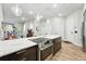 Chic kitchen with quartz counters, stainless appliances, dark cabinets, and an open layout to the living area at 6619 E Lowry Blvd # 101, Denver, CO 80230