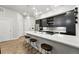 Modern kitchen features stainless steel appliances, stylish island with seating, and dark cabinets at 6619 E Lowry Blvd # 101, Denver, CO 80230