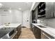 This kitchen boasts stainless steel appliances, quartz countertops, and dark wood cabinetry at 6619 E Lowry Blvd # 101, Denver, CO 80230