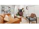 Cozy living room showcasing wood floors, comfortable seating, and seamless flow to the outdoor balcony at 6619 E Lowry Blvd # 101, Denver, CO 80230