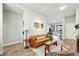 Bright living area boasts wood flooring, comfortable leather seating, and natural light from adjacent room at 6619 E Lowry Blvd # 101, Denver, CO 80230