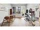 Bright room with large window, an ergonomic workspace, and a round table with chairs at 6619 E Lowry Blvd # 101, Denver, CO 80230