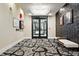 Lobby with patterned carpet, unique lighting fixture, textured wall, bench, and double-door entrance at 6619 E Lowry Blvd # 101, Denver, CO 80230