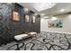 Inviting lobby area with stylish wall decor, accent lighting, and patterned flooring at 6619 E Lowry Blvd # 101, Denver, CO 80230