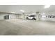 Spacious parking garage with ample parking, storage cabinet, and visible parking lines at 6619 E Lowry Blvd # 101, Denver, CO 80230