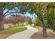 Scenic view of a peaceful walking path lined with trees and landscaping at 6619 E Lowry Blvd # 101, Denver, CO 80230