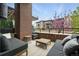 Cozy outdoor patio with comfortable seating, brick accents, and community view at 6619 E Lowry Blvd # 101, Denver, CO 80230