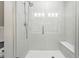 Elegant walk-in shower featuring a frameless glass door, shower head and built-in bench at 6619 E Lowry Blvd # 101, Denver, CO 80230
