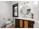 Bathroom with wooden vanity, designer fixtures, and a decorative mirror for a touch of elegance at 7267 Comanche Ct, Larkspur, CO 80118