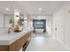 This is a luxurious bathroom with white tiling, a soaking tub, and large mirrors at 7267 Comanche Ct, Larkspur, CO 80118