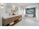 This elegant bathroom features dual sinks, a glass-enclosed shower, and marble countertops at 7267 Comanche Ct, Larkspur, CO 80118