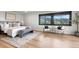 Bright bedroom with neutral decor, large windows, and a serene view at 7267 Comanche Ct, Larkspur, CO 80118