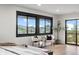 This bedroom has large windows with picturesque mountain views and a slider to the deck at 7267 Comanche Ct, Larkspur, CO 80118
