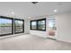 Bonus room has large windows with dark trim with beautiful lake and mountain views and access to the exterior at 7267 Comanche Ct, Larkspur, CO 80118