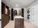 A spacious walk-in closet with custom shelving and a center island for organization at 7267 Comanche Ct, Larkspur, CO 80118