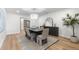 Stylish dining room with modern chandelier, large mirror, sleek furniture, and elegant decor at 7267 Comanche Ct, Larkspur, CO 80118