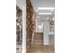 Inviting hallway featuring a stone accent wall and modern lighting fixtures at 7267 Comanche Ct, Larkspur, CO 80118