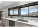 Bright kitchen featuring a stainless steel sink, white countertops, and a large window with a view at 7267 Comanche Ct, Larkspur, CO 80118