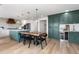 Bright, open kitchen featuring a large island, modern appliances, and an adjacent dining area at 7267 Comanche Ct, Larkspur, CO 80118