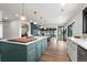 Bright, open kitchen featuring an island with counter seating and views of the backyard at 7267 Comanche Ct, Larkspur, CO 80118