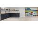 Finished basement kitchenette with blue cabinets, butcher block countertops, tile backsplash and original bear artwork at 7267 Comanche Ct, Larkspur, CO 80118