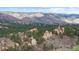 Scenic landscape with rugged rock formations, dense pine forests, and panoramic mountain views at 7267 Comanche Ct, Larkspur, CO 80118