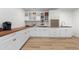 A spacious laundry room is equipped with plenty of cabinets and countertops at 7267 Comanche Ct, Larkspur, CO 80118