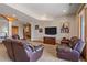 Basement featuring plush seating, entertainment center, and archway at 1015 Nob Hill Rd, Evergreen, CO 80439