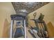Home gym featuring stone accents, treadmill, elliptical and weight rack for workout needs at 1015 Nob Hill Rd, Evergreen, CO 80439