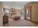 Bright bedroom with large windows providing natural light and access to an outdoor terrace at 1015 Nob Hill Rd, Evergreen, CO 80439