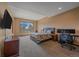Spacious bedroom featuring neutral tones, a large window with scenic views, and a dedicated desk area at 1015 Nob Hill Rd, Evergreen, CO 80439