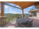 A covered deck featuring a wrought iron table set with mountain views at 1015 Nob Hill Rd, Evergreen, CO 80439