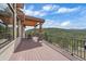 Spacious deck with vaulted wood ceilings offers beautiful views of the surrounding mountains at 1015 Nob Hill Rd, Evergreen, CO 80439