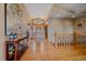 Bright foyer featuring hardwood floors, staircase, chandelier and a decorative wooden front door at 1015 Nob Hill Rd, Evergreen, CO 80439