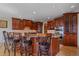 Gourmet kitchen with granite countertops, custom cabinetry, and a center island with seating at 1015 Nob Hill Rd, Evergreen, CO 80439